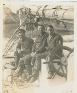 Image: Abie and two men on wheel box of Bowdoin